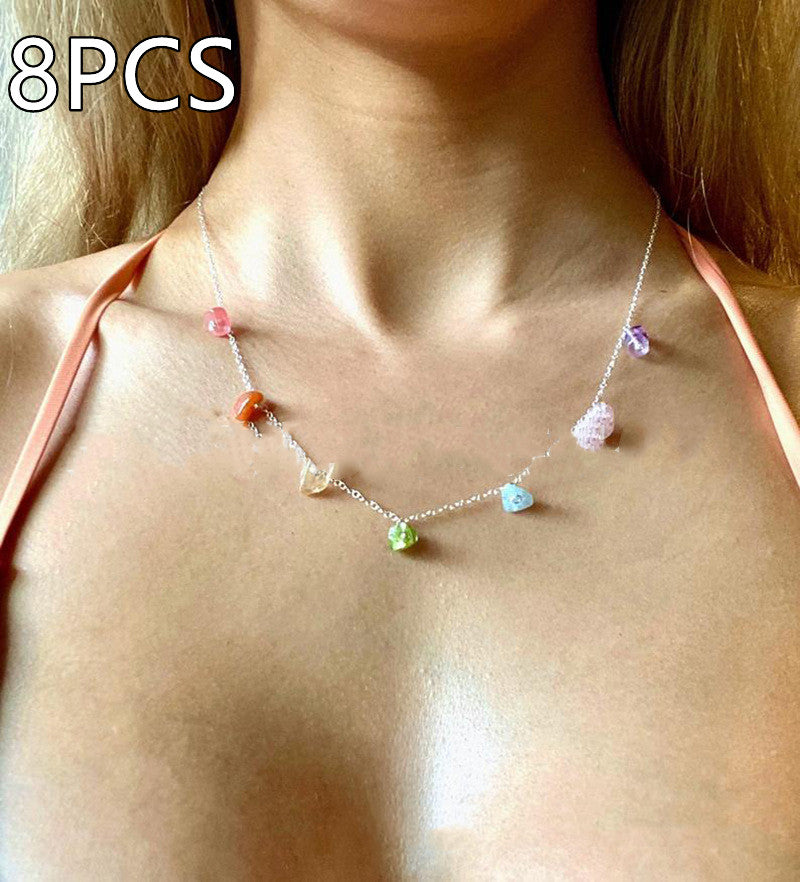 Gold crystal pendant necklace with dangling purple and white crystal bead accents