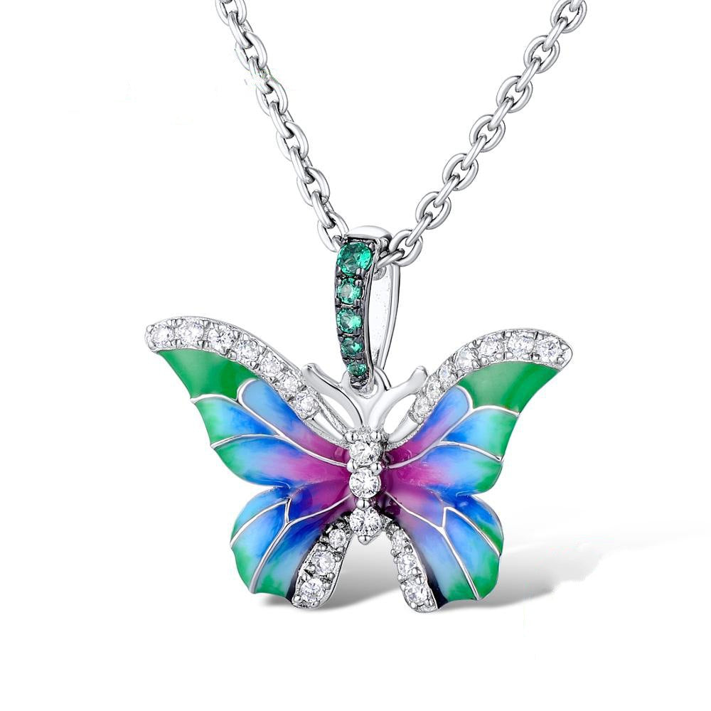 Butterfly enamel pendant necklace with green center stone and multicolor wing enamel