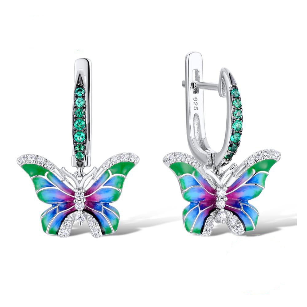 Butterfly enamel hoop earrings with emerald-green accents and multicolor enamel wings