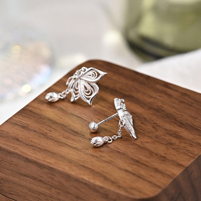 Sterling silver butterfly tassel earrings shown from side with dangling teardrop charm
