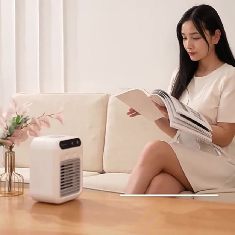 Ivory mini air cooler fan on a coffee table with front vent and top controls