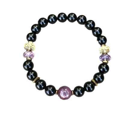 Black round bead bracelet with a purple center gemstone and small crystal-like spacers