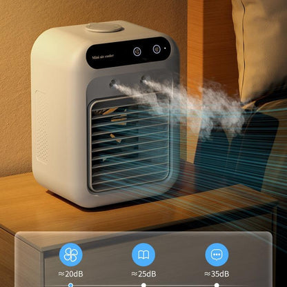 Ivory mini air cooler fan on a bedside table with visible mist from front grille