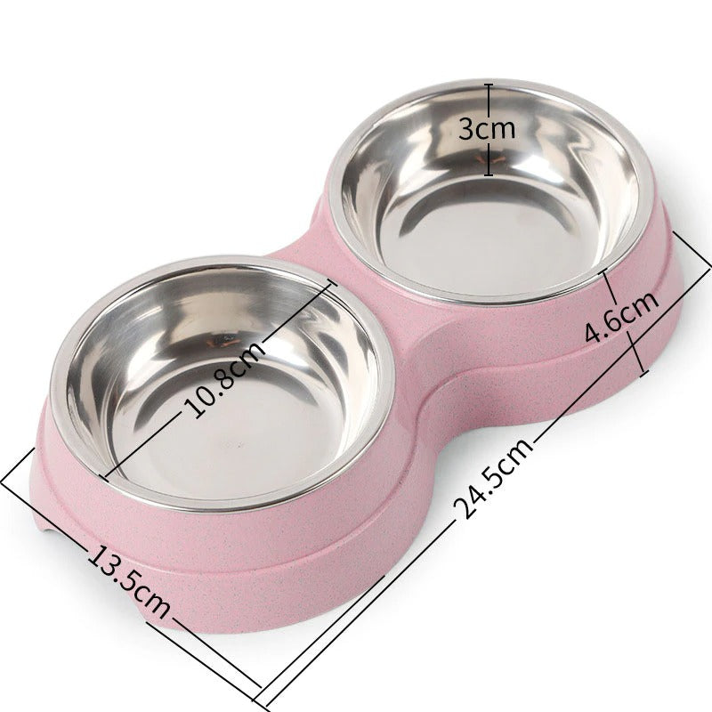 Double pet bowl with two stainless steel dishes on pink base, 24.5cm long, 13cm wide