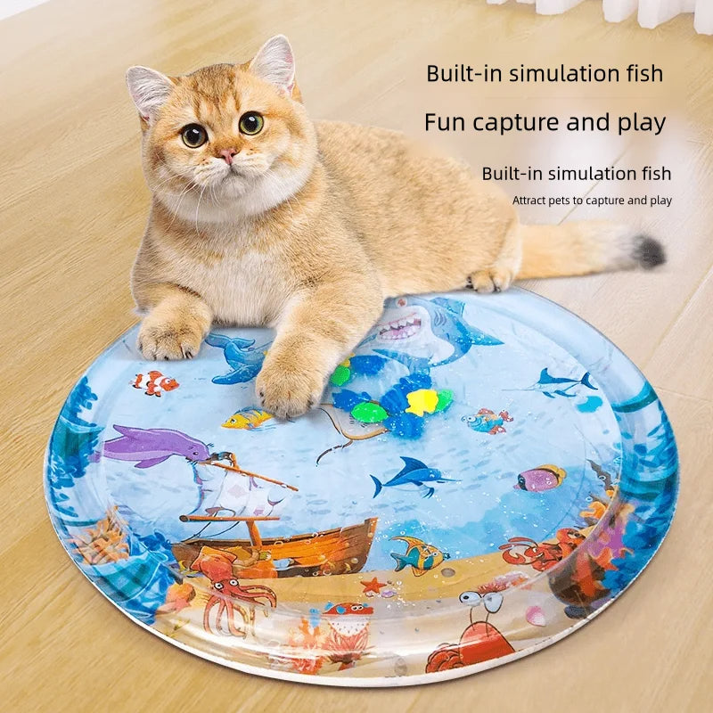 Inflatable round pet cooling water mat with ocean animal print, with cat lying beside it