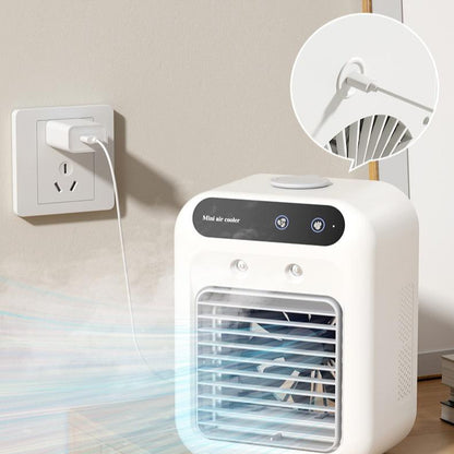Ivory mini air cooler fan near a wall outlet, with front grille and control panel